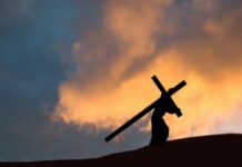 The cross A picture representation of Jesus carrying the cross on a hill